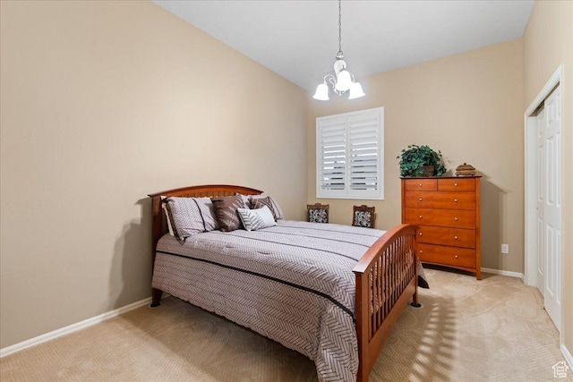 bedroom featuring a notable chandelier, baseboards, and light colored carpet