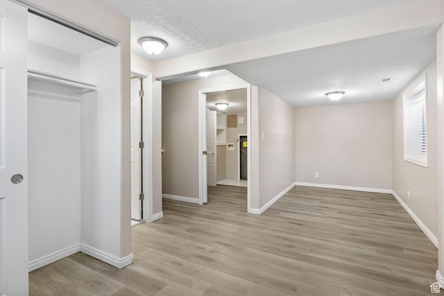 8475 S 1520 W, West Jordan, UT 84088 - basement featuring light wood-style floors, baseboards, and a textured ceiling