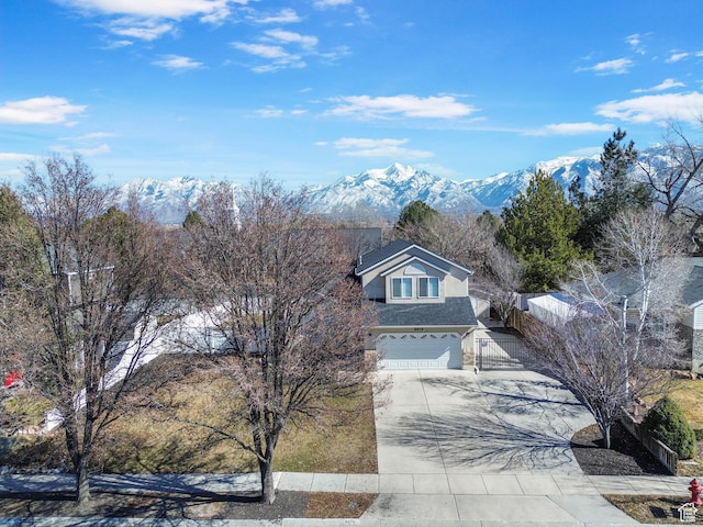 8475 S 1520 W, West Jordan, UT 84088 - view of front of home featuring concrete driveway, an attached garage, fence, and a mountain view