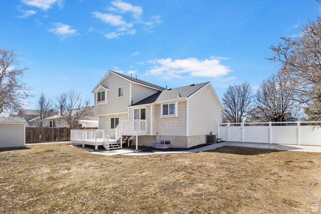 8475 S 1520 W, West Jordan, UT 84088 - rear view of property featuring a deck, central AC unit, a lawn, and a fenced backyard