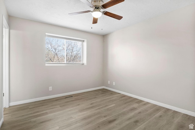 8475 S 1520 W, West Jordan, UT 84088 - unfurnished room featuring baseboards, a textured ceiling, visible vents, and wood finished floors