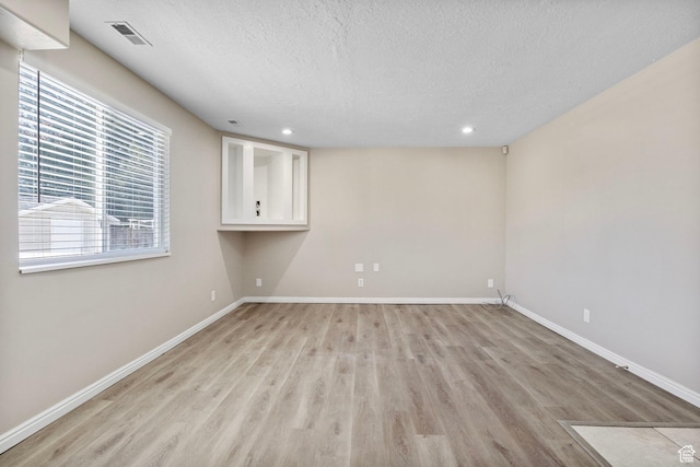 8475 S 1520 W, West Jordan, UT 84088 - empty room featuring a textured ceiling, light wood-style flooring, recessed lighting, visible vents, and baseboards