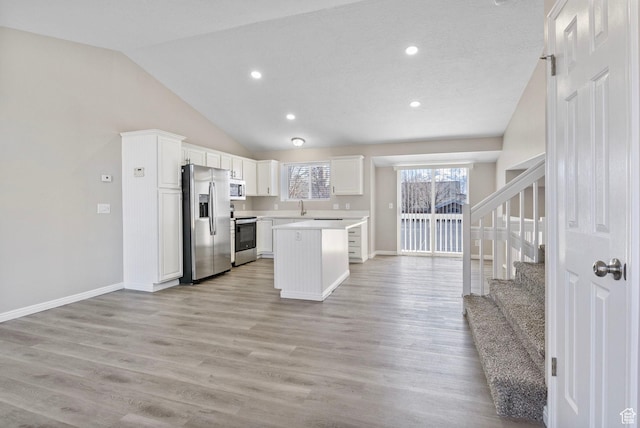8475 S 1520 W, West Jordan, UT 84088 - kitchen featuring light wood-type flooring, white cabinetry, appliances with stainless steel finishes, and light countertops