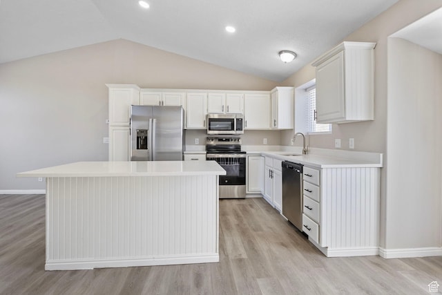 8475 S 1520 W, West Jordan, UT 84088 - kitchen with white cabinets, a kitchen island, appliances with stainless steel finishes, light countertops, and a sink