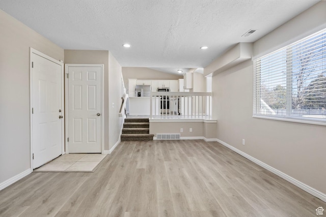 8475 S 1520 W, West Jordan, UT 84088 - unfurnished room featuring stairway, baseboards, visible vents, and light wood finished floors