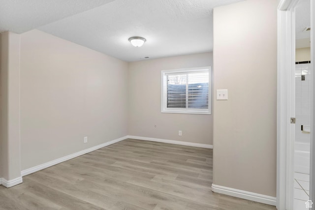 8475 S 1520 W, West Jordan, UT 84088 - spare room with light wood-type flooring, a textured ceiling, and baseboards
