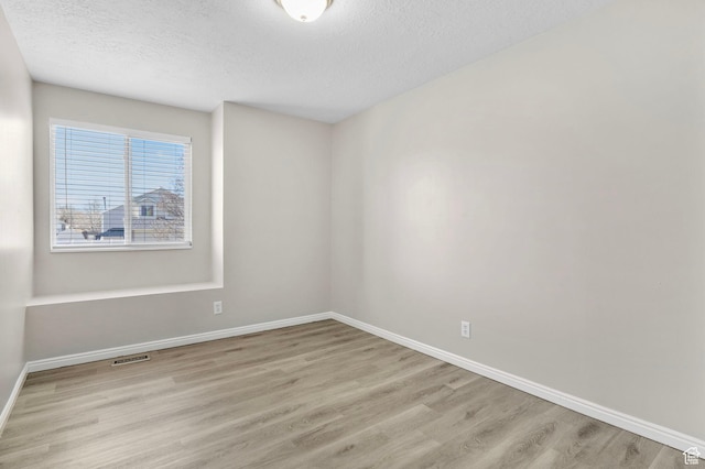 8475 S 1520 W, West Jordan, UT 84088 - unfurnished room featuring a textured ceiling, wood finished floors, and baseboards