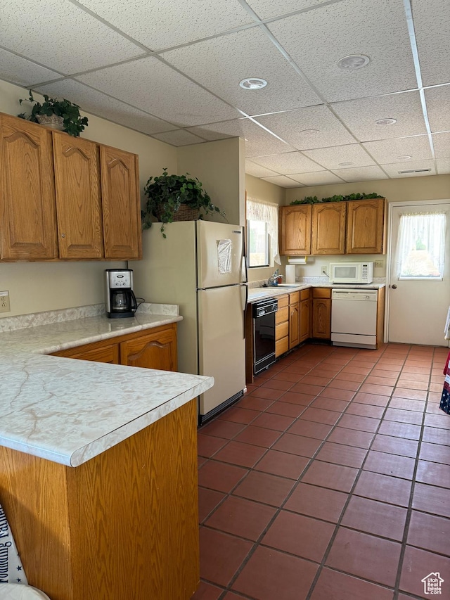 1526 N Dixie Downs Rd N 36, St George, UT 84770 - kitchen featuring light countertops, white appliances, brown cabinetry, and plenty of natural light
