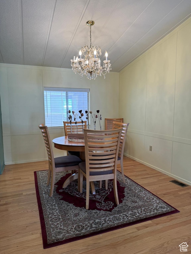 1526 N Dixie Downs Rd N 36, St George, UT 84770 - dining space with a textured ceiling, light wood finished floors, visible vents, and a decorative wall