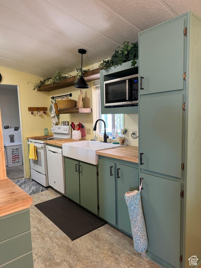 1526 N Dixie Downs Rd N 36, St George, UT 84770 - kitchen with white appliances, a sink, decorative light fixtures, and butcher block counters