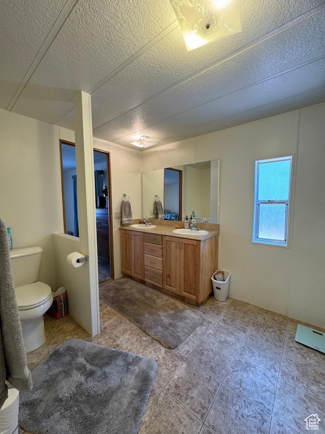 1526 N Dixie Downs Rd N 36, St George, UT 84770 - bathroom with a sink, a textured ceiling, and double vanity
