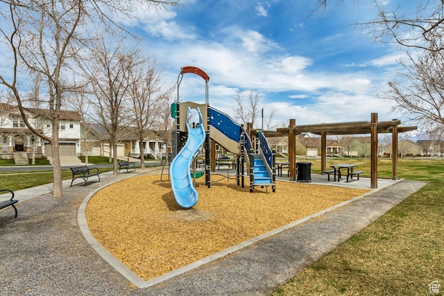 community jungle gym featuring a residential view and a lawn
