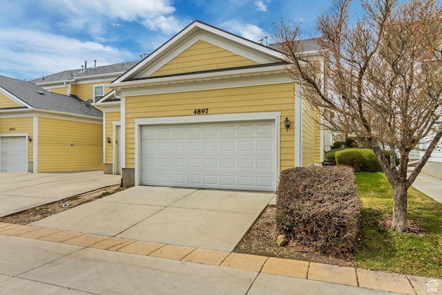 view of front of home with a garage and concrete driveway