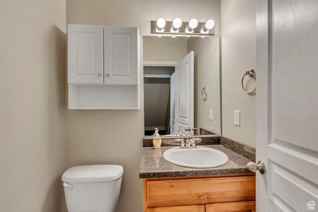 half bath with vanity and toilet