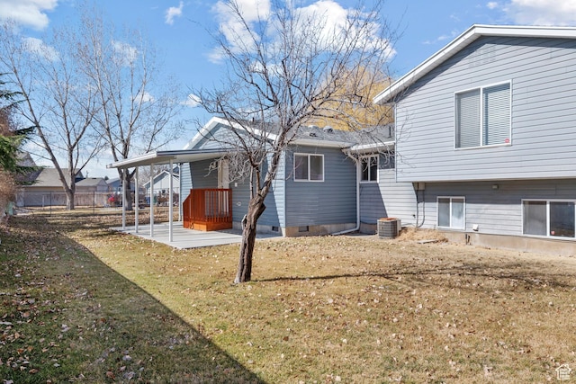 back of property featuring a lawn and cooling unit