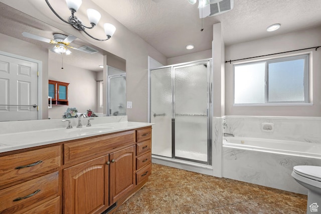 bathroom featuring visible vents, a garden tub, vanity, and a textured ceiling