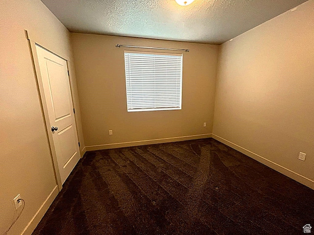 154 E 7th St S Unit A101, Ogden, UT 84404 - unfurnished room featuring carpet floors, a textured ceiling, and baseboards