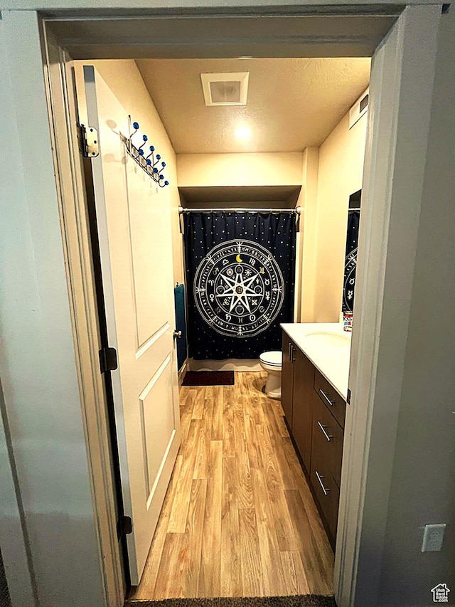 154 E 7th St S Unit A101, Ogden, UT 84404 - bathroom with wood finished floors, toilet, and vanity
