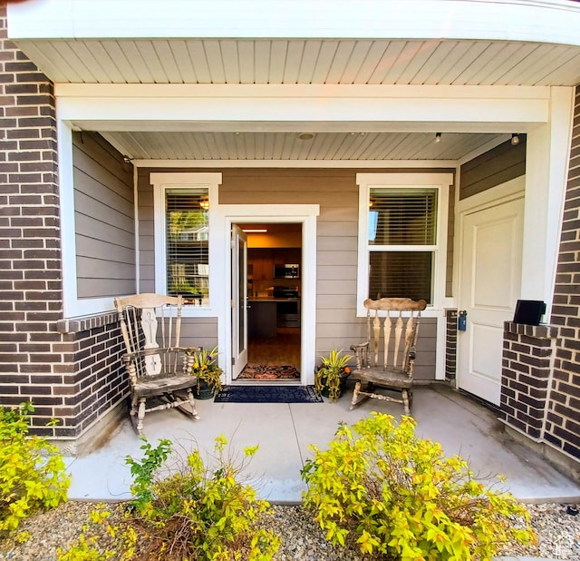 154 E 7th St S Unit A101, Ogden, UT 84404 - doorway to property with brick siding and covered porch
