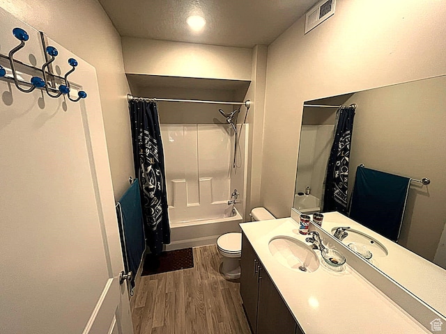 154 E 7th St S Unit A101, Ogden, UT 84404 - bathroom featuring wood finished floors, toilet, vanity, and shower / bath combination with curtain