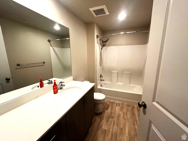154 E 7th St S Unit A101, Ogden, UT 84404 - full bathroom with wood finished floors, toilet, vanity, and shower / washtub combination