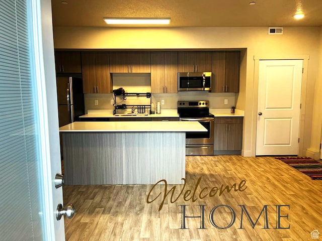 kitchen with visible vents, light wood-style floors, appliances with stainless steel finishes, and light countertops