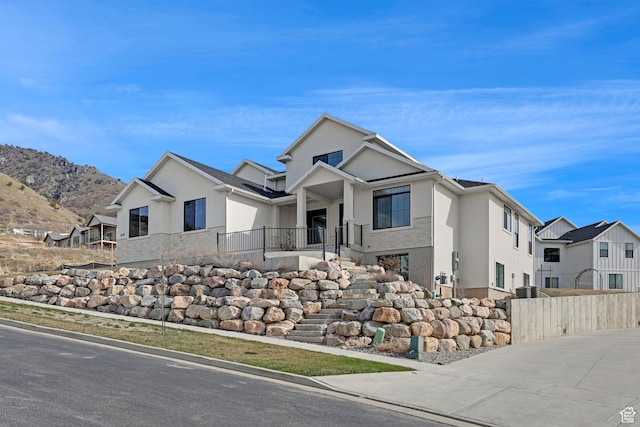 680 E 525 N, Providence, UT 84332 - view of front of house featuring a mountain view, stucco siding, and fence
