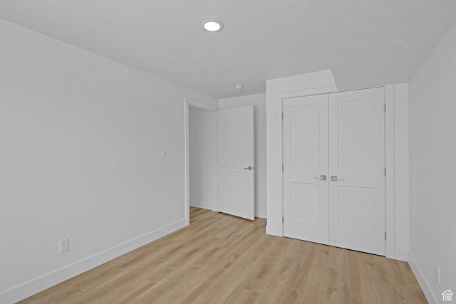 680 E 525 N, Providence, UT 84332 - unfurnished bedroom featuring light wood-style flooring, a closet, baseboards, and recessed lighting