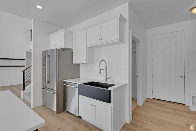 680 E 525 N, Providence, UT 84332 - kitchen with stainless steel appliances, light countertops, white cabinetry, and a sink