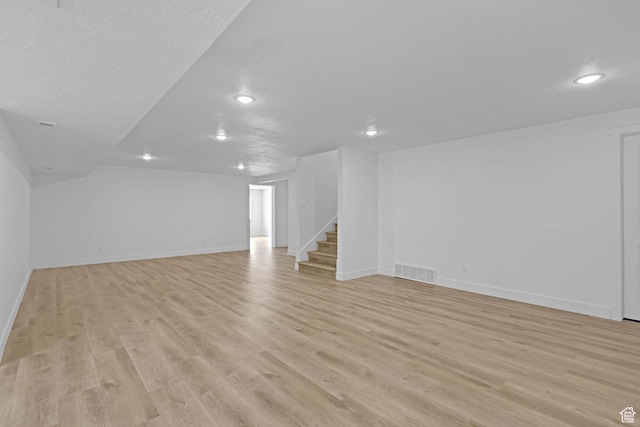 680 E 525 N, Providence, UT 84332 - unfurnished living room with visible vents, baseboards, light wood-type flooring, recessed lighting, and stairway