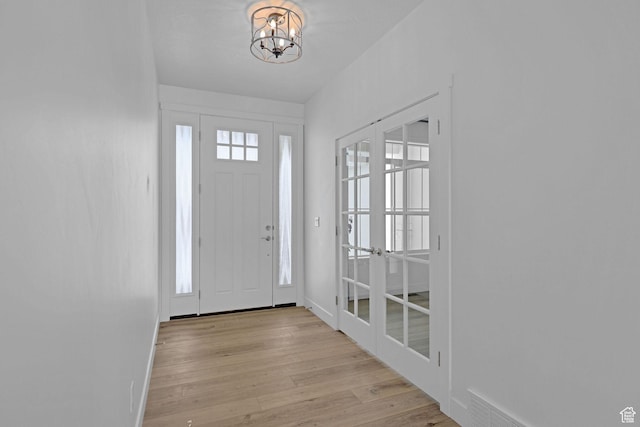 680 E 525 N, Providence, UT 84332 - entryway featuring light wood finished floors, a notable chandelier, baseboards, and french doors