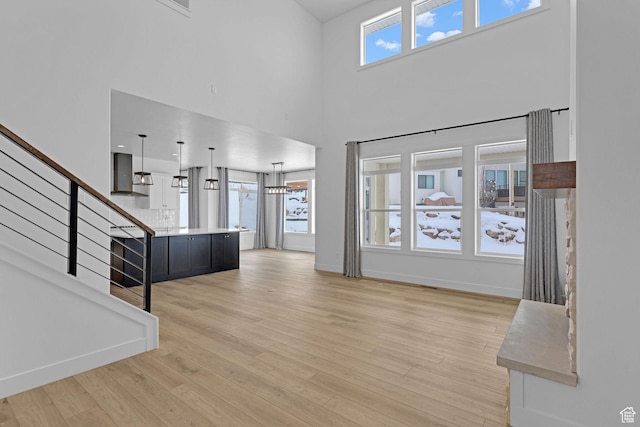 680 E 525 N, Providence, UT 84332 - entryway with light wood-style flooring, a high ceiling, a wealth of natural light, and stairway