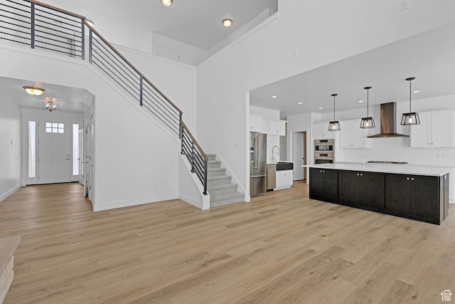 680 E 525 N, Providence, UT 84332 - kitchen featuring light countertops, white cabinetry, wall chimney exhaust hood, stainless steel appliances, and a sink
