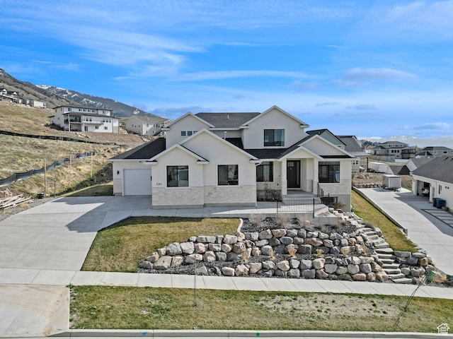 view of front of home featuring a garage, stucco siding, a front lawn, driveway, and a residential view