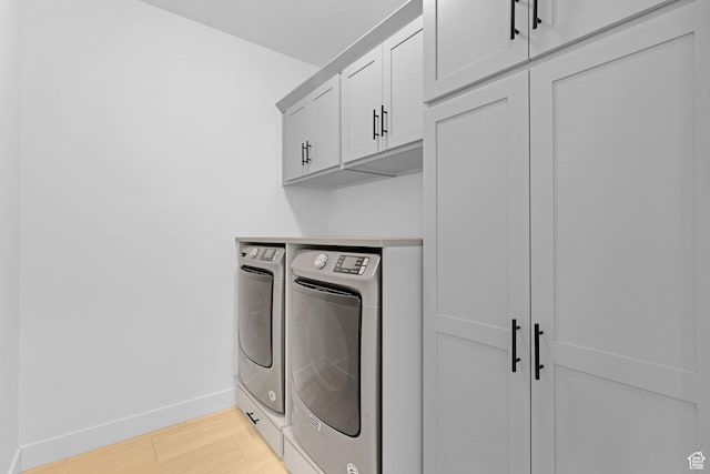 680 E 525 N, Providence, UT 84332 - laundry area featuring separate washer and dryer, baseboards, light wood-style flooring, and cabinet space