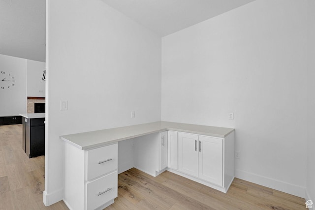 680 E 525 N, Providence, UT 84332 - unfurnished office featuring built in desk, light wood finished floors, and baseboards