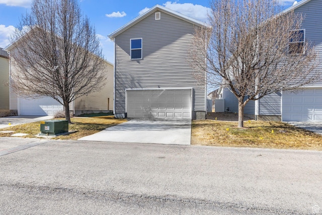 view of front of property featuring a garage and concrete driveway