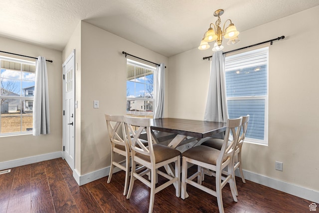 dining area with baseboards, a chandelier, and dark wood-style flooring