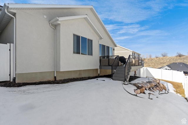 1313 E Daffodil Ct, Layton, UT 84040 - view of snowy exterior featuring stairway, fence, and stucco siding