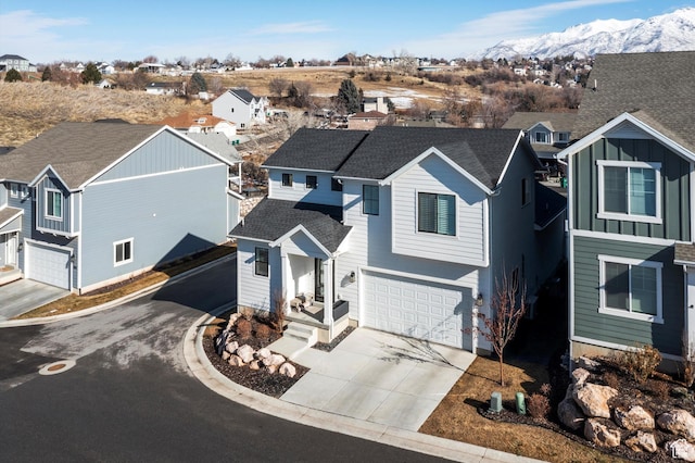 1313 E Daffodil Ct, Layton, UT 84040 - traditional-style house featuring a residential view, concrete driveway, roof with shingles, and a mountain view
