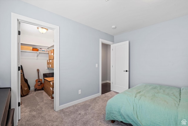 1313 E Daffodil Ct, Layton, UT 84040 - bedroom featuring a walk in closet, a closet, light colored carpet, and baseboards