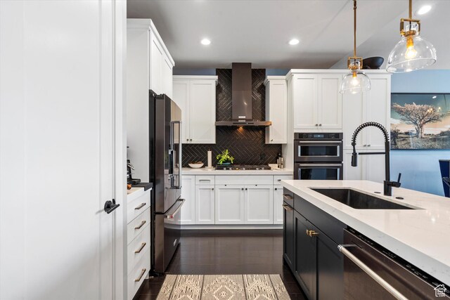 1313 E Daffodil Ct, Layton, UT 84040 - kitchen featuring stainless steel appliances, a sink, white cabinets, wall chimney range hood, and pendant lighting