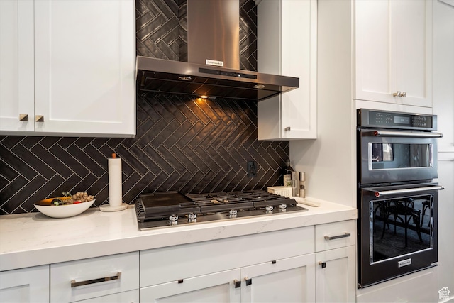 1313 E Daffodil Ct, Layton, UT 84040 - kitchen featuring multiple ovens, stainless steel gas stovetop, wall chimney exhaust hood, and white cabinetry