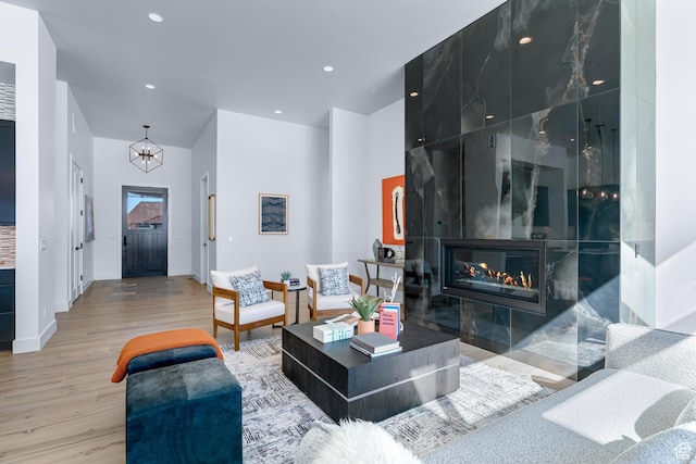 272 Thorn Creek Dr, Kamas, UT 84036 - living room with wood finished floors, a chandelier, recessed lighting, baseboards, and a fireplace