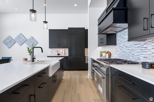 272 Thorn Creek Dr, Kamas, UT 84036 - kitchen with stainless steel stove, a sink, custom range hood, pendant lighting, and light wood-style flooring