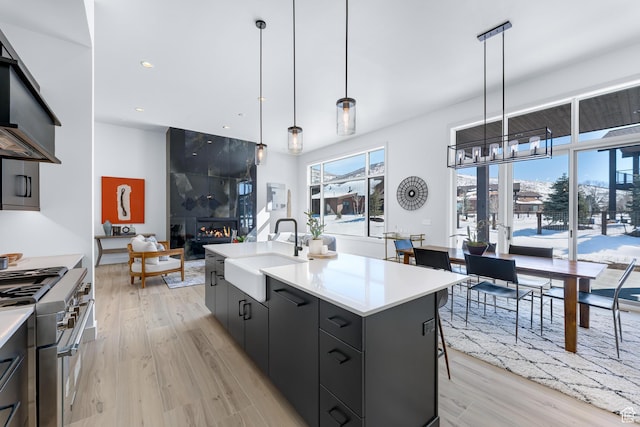 272 Thorn Creek Dr, Kamas, UT 84036 - kitchen with stainless steel stove, a sink, light wood-style flooring, light countertops, and recessed lighting