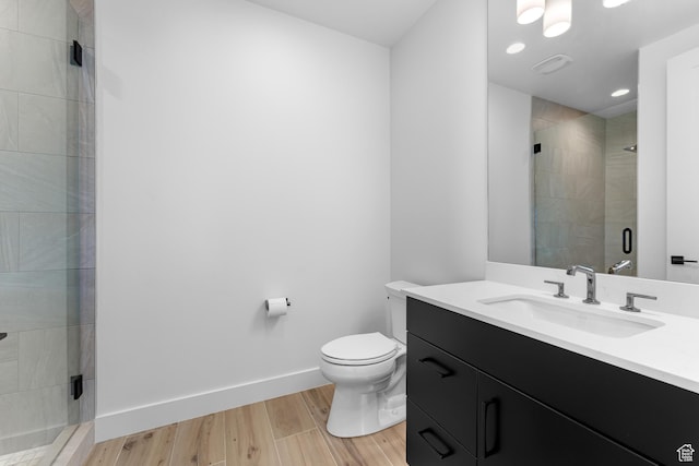272 Thorn Creek Dr, Kamas, UT 84036 - full bathroom featuring vanity, toilet, a shower stall, wood finished floors, and baseboards