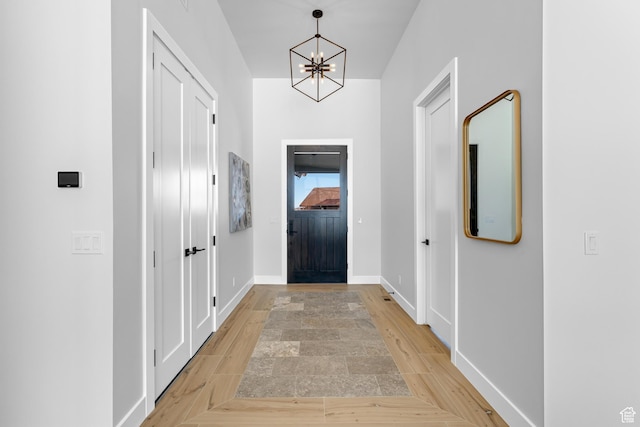 272 Thorn Creek Dr, Kamas, UT 84036 - foyer entrance featuring a chandelier, baseboards, and light wood-type flooring
