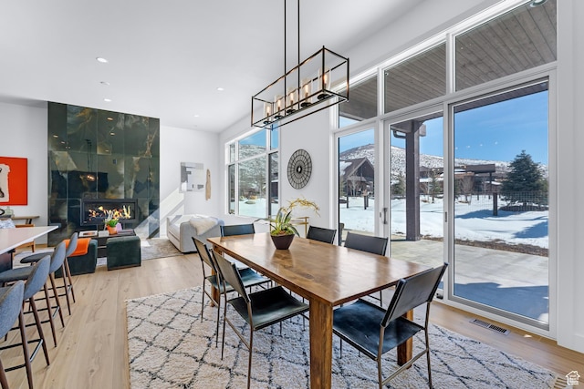 272 Thorn Creek Dr, Kamas, UT 84036 - dining area with light wood-type flooring, recessed lighting, and a tiled fireplace