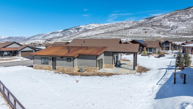 272 Thorn Creek Dr, Kamas, UT 84036 - snow covered back of property featuring stone siding, a mountain view, and a residential view